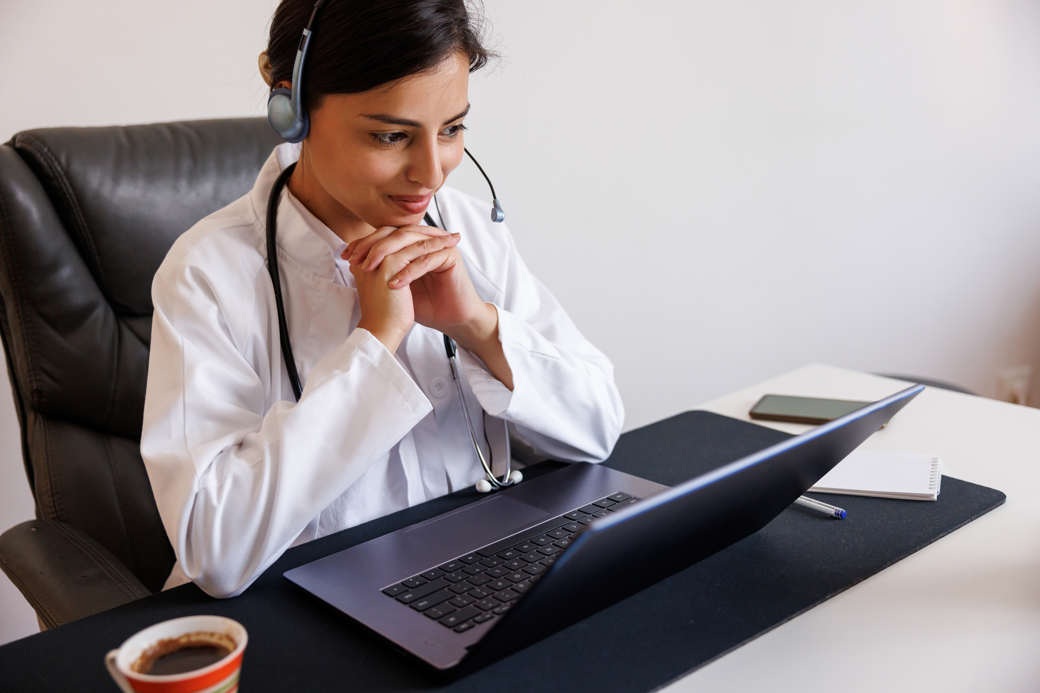 Young female doctor using a laptop at work