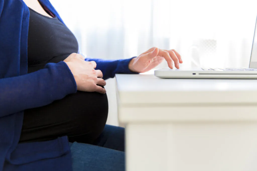 Pregnant woman using her laptop