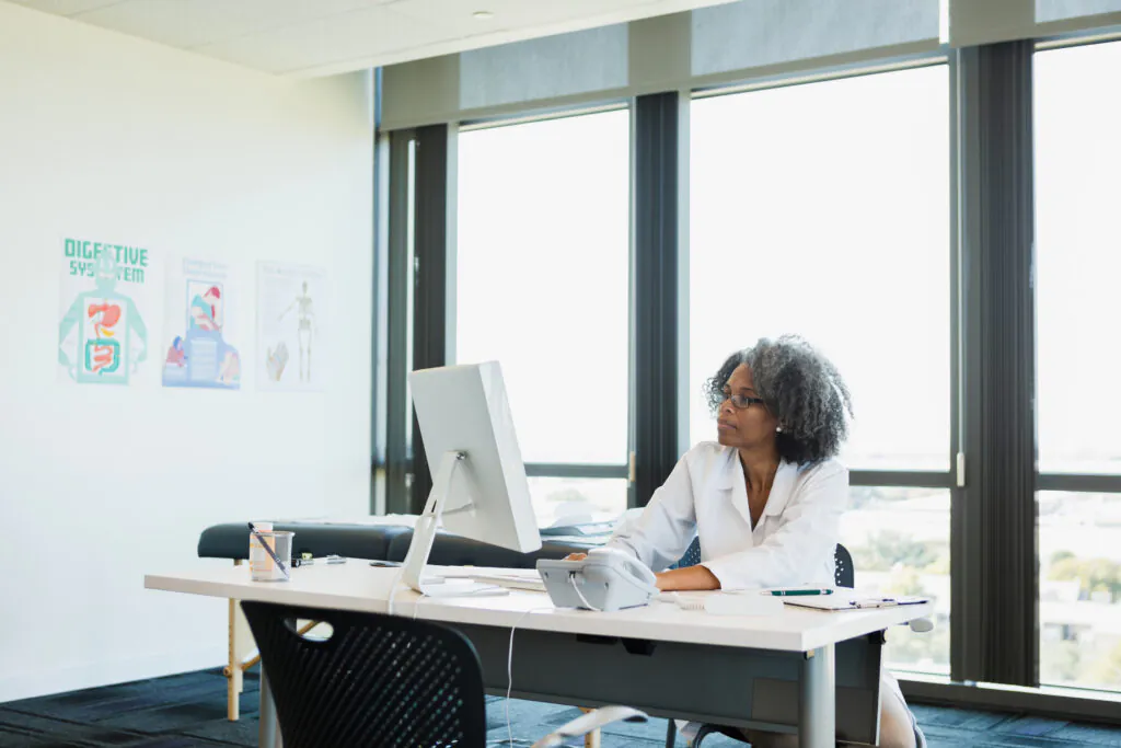 Mature female doctor works in office